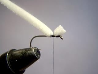 Step 2 Offer up closed-cell foam ON TOP of the hook shank and secure with 2 or 3 turns of thread. Then run the tying thread down the thorax area, binding down the closed-cell foam.