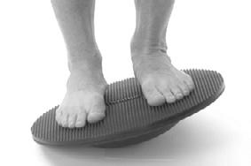 Begin with board parallel to ground and rock board from side to side by bending your knees and ankles.