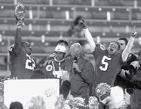 Smith, Ron McBride and Jay Hill celebrate Utah s 1999 Las Vegas Bowl win over