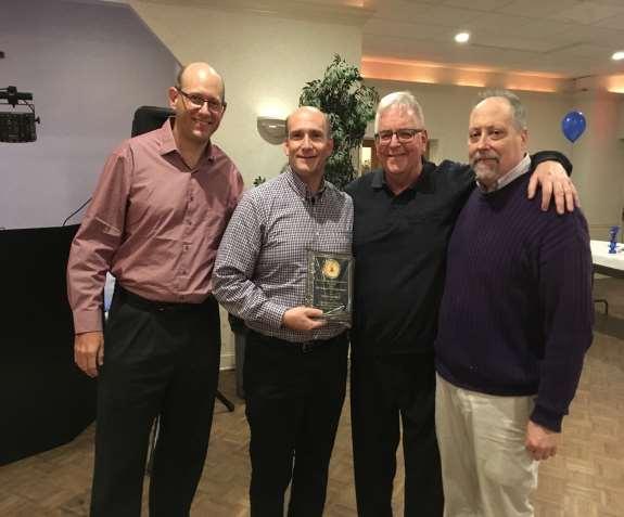 STEVE JUCHEM IS AWARDED THE RUNNER OF THE YEAR PLAQUE AT THE SOCIAL ON JANUARY 27 TH.