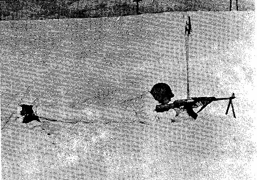 Pic. 27 - The ''Lay down LOAD'' position for firing the machine gun, with the skis turned aside When firing in deep snow, the ski poles, skis, and other available objects can be used as rests for the