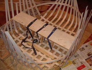 The laths are bent one by one, starting from the lengthwise and crosswise mid lath, proceeding towards corners. The laths can be attached to the gunwale using small screws.