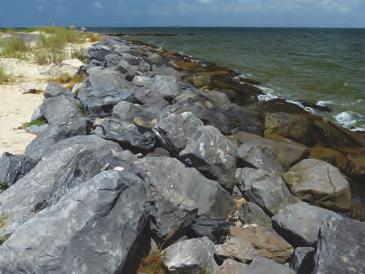 As shown in this photograph, large rocks and other debris can be placed along the coast to armor it, in an attempt to protect it from erosion. Material used in this way is called rip rap.