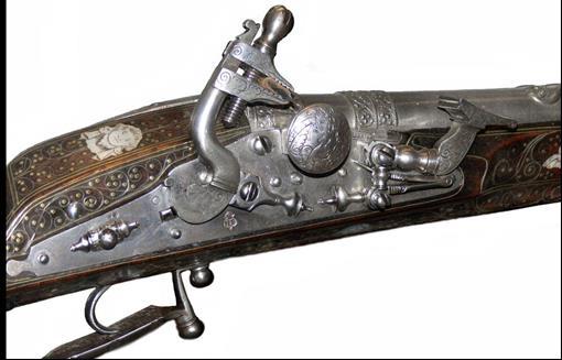 The magnificent pistols shown above have slender stocks inlaid with engraved mother-of-pearl and barrels and locks damascened in gold, and might have been among the gifts presented by Sir Thomas
