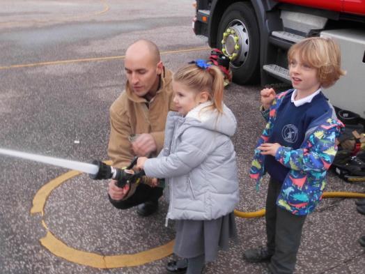 They were most excited to see the fire engine on the playground and even more excited to have the opportunity to hold the hose and spray the water.
