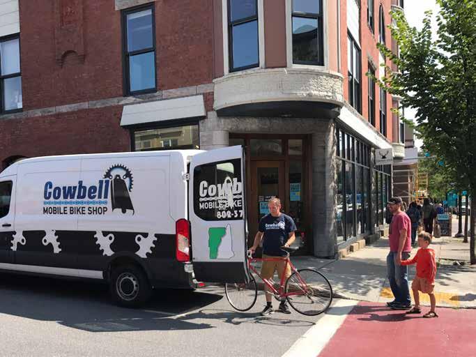 Todd picks up a bike needing repairs in Burlington, Vermont. The Cowbell van is well stocked to service a whole fleet of bikes.