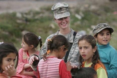 Four veterans from one unit have killed self Credit: Provided Sgt. April James with a group of Iraqi children on her second deployment.