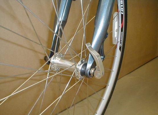 Insert the wheel between the fork blades so that the axle seats firmly at the top of the fork dropouts (1-A), which are at the tips of the fork blades.