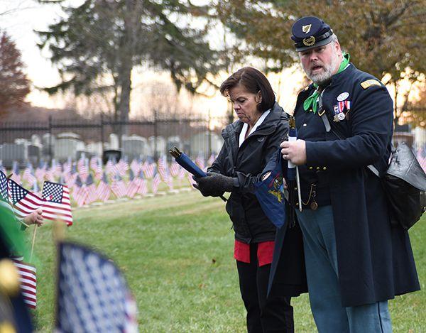 The 14 th Michigan and volunteers from the the Department of Michigan placed National and State flags on the headstones of