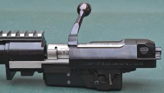 On the right side and at the rear is the bolt stop which when depressed allows the bolt and the bolt carrier to be removed for cleaning.