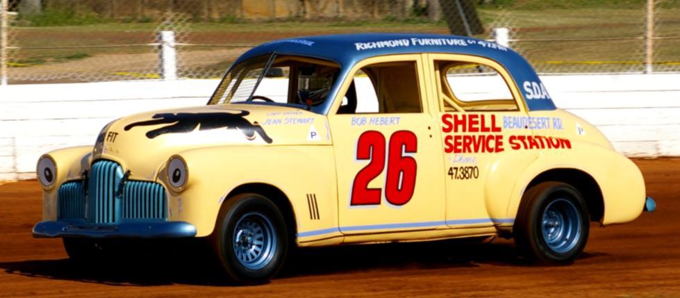Photo by Col s Action Photo s 1948-1953 HOLDEN FX SALOON CAR GREY MOTOR 1948-1956 History: This car is a replica of Saloon Car QLD 26 raced by Bob Hebert and Jean Stewart (Lady Driver).