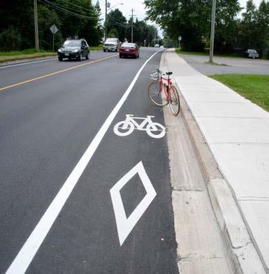 A conventional bicycle lane is a portion of a roadway which has been designated by pavement markings and signage for the preferential or