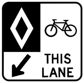 Cyclists are separated from motorists by a solid white line. Bike lanes are installed adjacent to the curb.
