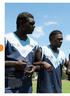 Making a stand: The Tuyu Buffaloes link arms in a show of solidarity against domestic violence before kick-off at the 2016 Tiwi Islands Football